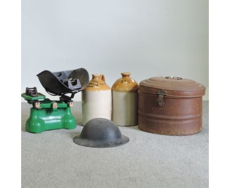 A World War I helmet, in a metal hat box, together with a set of cast iron scales and weights, and two advertising jars