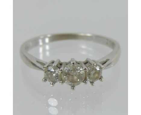 An 18 carat white gold three stone diamond ring, approximately 1/2 carat