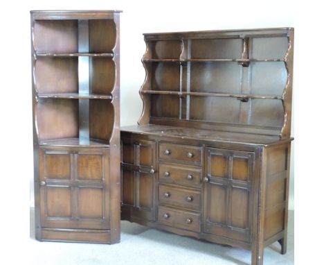 An Ercol dark elm dresser, 143cm, together with a matching corner cabinet, 184cm tall