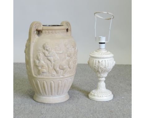 A plaster urn, with relief decoration, 37cm tall, together with a carved table lamp 