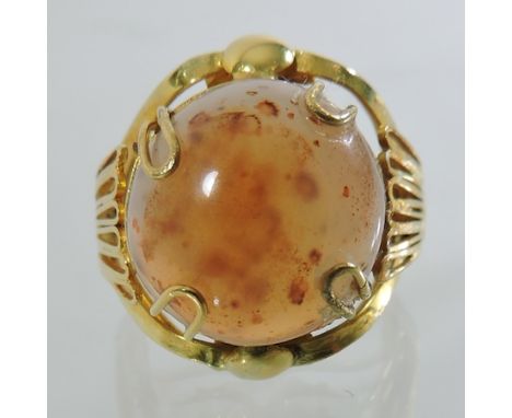 An unmarked gem set ring, in a scrolled openwork setting, boxed