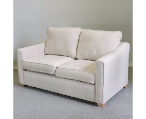 A cream upholstered two seater sofa bed, 157cm