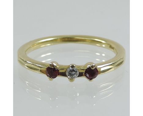 An 18 carat gold diamond and ruby three stone ring