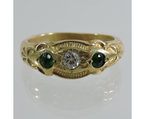 An 18 carat gold, emerald and diamond ring 