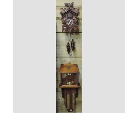 A cuckoo clock, 63cm tall, together with a drop dial wall clock 