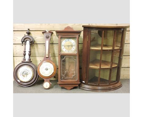 An oak glazed hanging corner cabinet, 50cm, together with a wall clock, a barometer and another