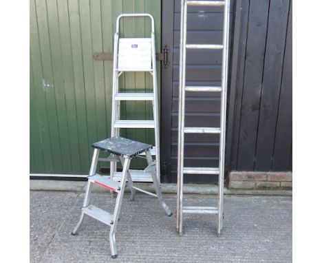 An extending aluminium ladder, together with two other step ladders 