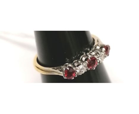 An 18 ct gold three stone ruby and diamond ring.