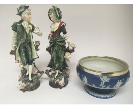 A pair of Continental ceramic ornaments of figures on naturalistic bases and a Wedgwood bowl (3)NO RESERVE
