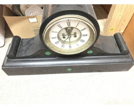 A large and heavy black slate mantle clock.