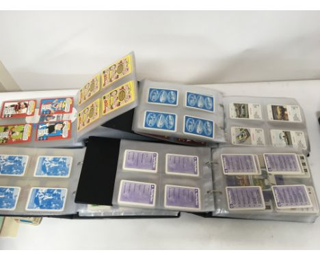 A collection of four albums containing mixed playing cards and vintage collectors cards postage Category C NO RESERVE.