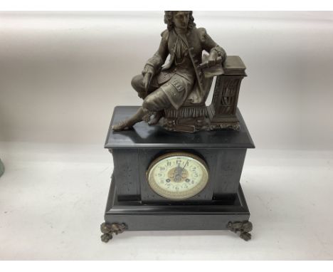 A slate mantle clock with classical figure on top. 30cm by 50cm approx.