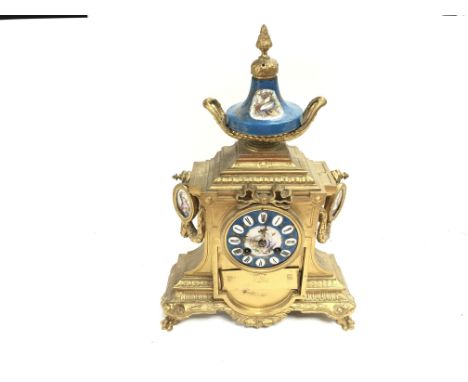 A French gilt and porcelain mantel clock. No reserve.