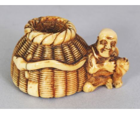 A GOOD QUALITY SIGNED JAPANESE MEIJI PERIOD IVORY NETSUKE OF A FISHERMAN, seated by his creel basket, the base with an engrav