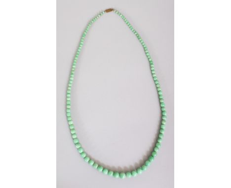 A CHINESE APPLE-GREEN JADE NECKLACE, composed of graduated spherical beads, approx. 27in long.