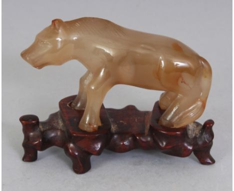A 20TH CENTURY CHINESE AGATE MODEL OF A STANDING HORSE, together with a fitted wood stand, 2.75in high overall, the horse its