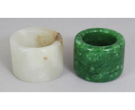A CHINESE WHITE JADE ARCHER'S RING, with russet inclusions, 1.3in diameter & 1.9in high; together with a spinach green jade-l