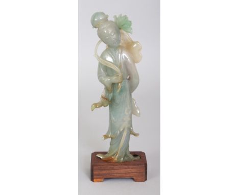 A 20TH CENTURY CHINESE JADE FIGURE OF A STANDING LADY, together with a fitted wood stand, the lady bearing a spray of lotus, 