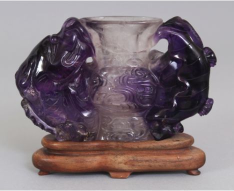 A 20TH CENTURY CHINESE AMETHYST GU VASE, together with a fitted wood stand, the vase of archaic form and carved in high relie