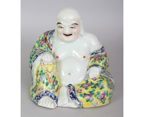 AN EARLY 20TH CENTURY CHINESE FAMILLE ROSE PORCELAIN FIGURE OF BUDAI, seated with exposed belly and cheerful expression and h