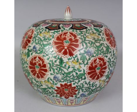 A CHINESE WUCAI GLOBULAR PORCELAIN JAR & COVER, the sides decorated with formal scroll-stemmed lotus, the base with a Qianlon