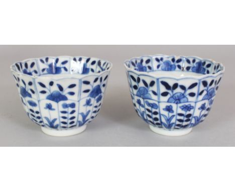 A PAIR OF 19TH CENTURY CHINESE KANGXI STYLE BLUE & WHITE FLUTED PORCELAIN TEABOWLS, with floral decoration, each base with a 