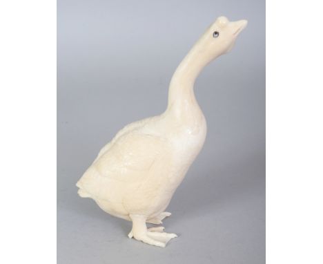 A FINE QUALITY JAPANESE MEIJI PERIOD IVORY OKIMONO OF A GOOSE, with mother-of-pearl inlaid eyes, its coat naturalistically ca