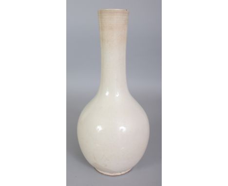 A CHINESE WHITE GLAZED CERAMIC VASE, the sides faintly incised underneath the glaze with bamboo and peach, the neck with form