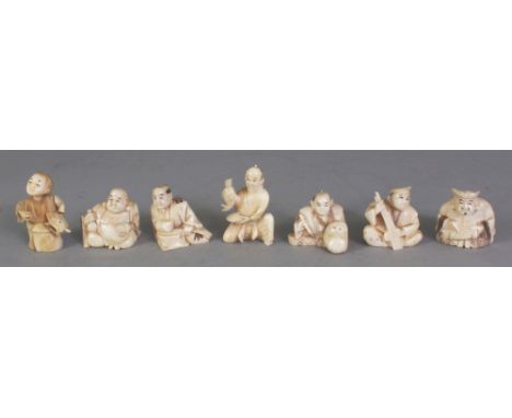 A GROUP OF FIVE EARLY 20TH CENTURY SIGNED JAPANESE IVORY NETSUKE, the tallest 1.6in high; together with two similarly carved 