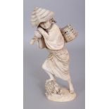 A GOOD QUALITY SIGNED JAPANESE MEIJI PERIOD IVORY OKIMONO OF AN ARTISAN, standing on rockwork and