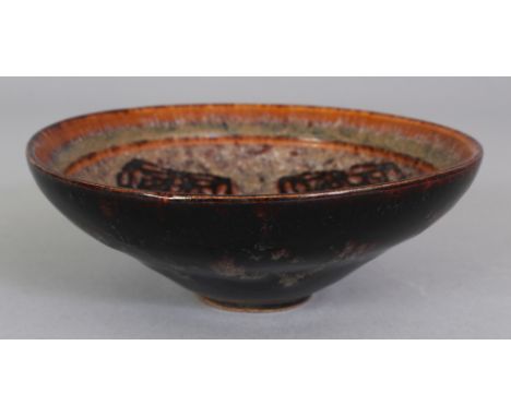 A CHINESE SONG STYLE JIZHOU PAPERCUT CERAMIC BOWL, the interior with three quatrefoil panels, the base unglazed, 5in diameter