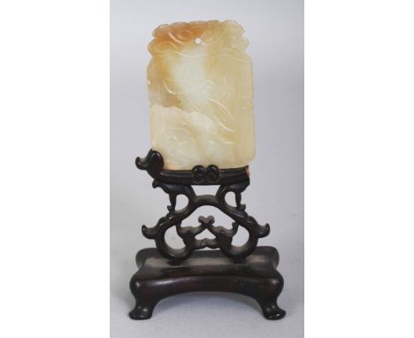 AN EARLY 20TH CENTURY CHINESE CELADON JADE SHAPED RECTANGULAR PENDANT, together with a fitted wood stand, the jade with russe