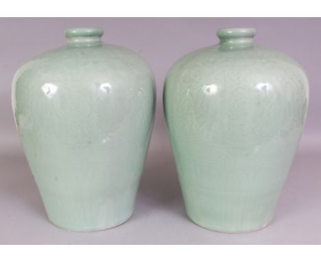 A LARGE PAIR OF CHINESE CELADON MEIPING PORCELAIN VASES, each carved beneath the glaze with a band of formal foliage within f