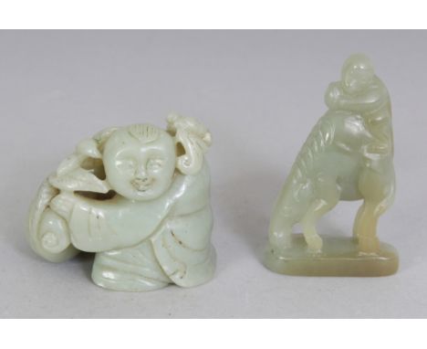 A CHINESE CELADON JADE MODEL OF A BOY, with a bag, lotus and a bat, 2.1in wide at widest point of base & 1.8in high; together
