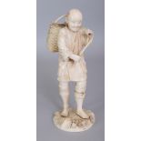 A SIGNED JAPANESE MEIJI PERIOD SECTIONAL IVORY OKIMONO OF A STANDING GRAPE HARVESTER, a basket of