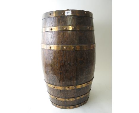 An early 20th century oak stick stand fashioned as a barrel with brass bands, 25.5 high