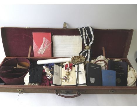 An early 20th century canvas and leather case containing Masonic regalia, to include a cased silver gilt and enamel crowned b