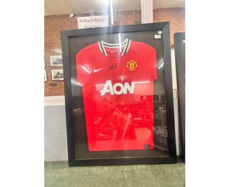 A Manchester United football shirt, signed by Ryan Giggs in mounted framed display