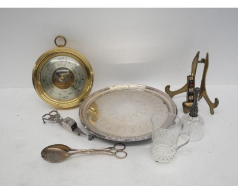 A collection of silver plated items to include a barometer, a wick cutter and snuffers, tongues, cow bell, glass bell and a p