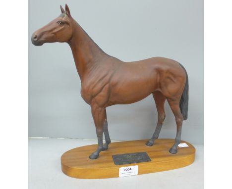 A large Beswick figure, Red Rum, on a teak plinth