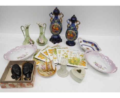 A collection of porcelain and ceramic items, includes two green jug vases, two cups and saucers, trinket box, two black and g