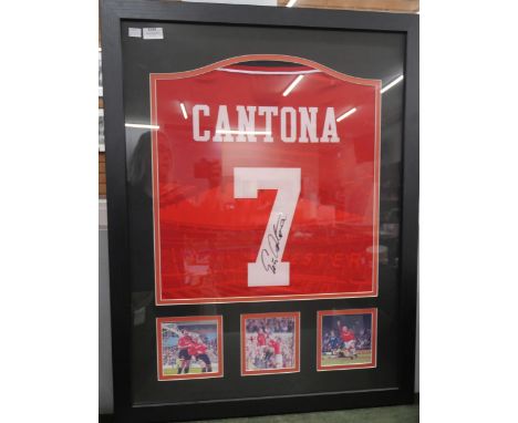 A Manchester United football shirt, signed by Eric Cantona, in framed photographic display, with certificate of authenticity
