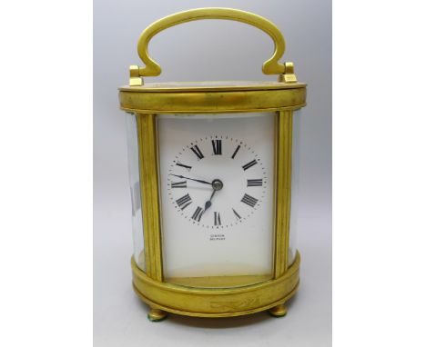 An oval shaped early 20th Century brass carriage clock, dial signed Gibson, Belfast