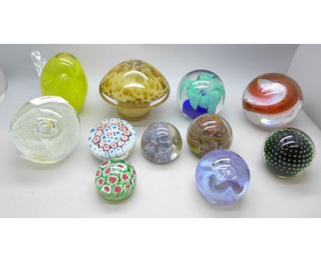 Eleven glass paperweights, one marked Caithness