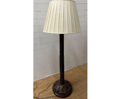 A carved floor standing lamp 