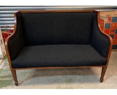 A two seater Edwardian sofa with mahogany inlaid frame, upholstered in black 