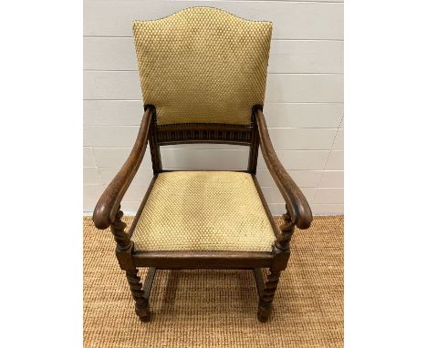 An oak elbow chair with barley twist front supports and upholstered seat pads 