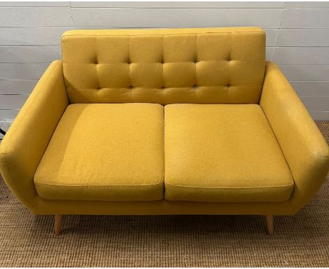 A Mid Century style mustard upholstered two seater button back sofa 