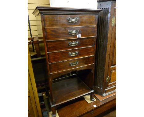 AN EDWARDIAN POLISHED MUSIC CABINET having five fall front drawers with copperized handles and a base shelf