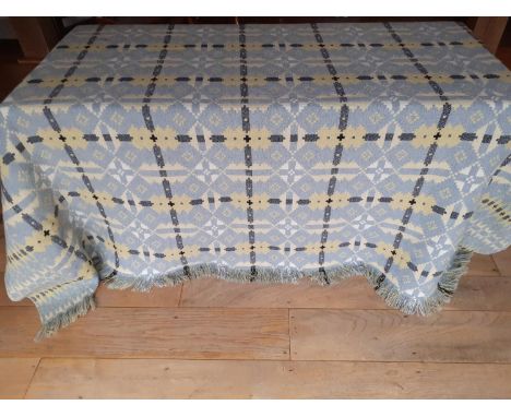 A vintage Welsh reversible woollen blanket having a cornflower blue ground to one side with yellow, white and black geometric